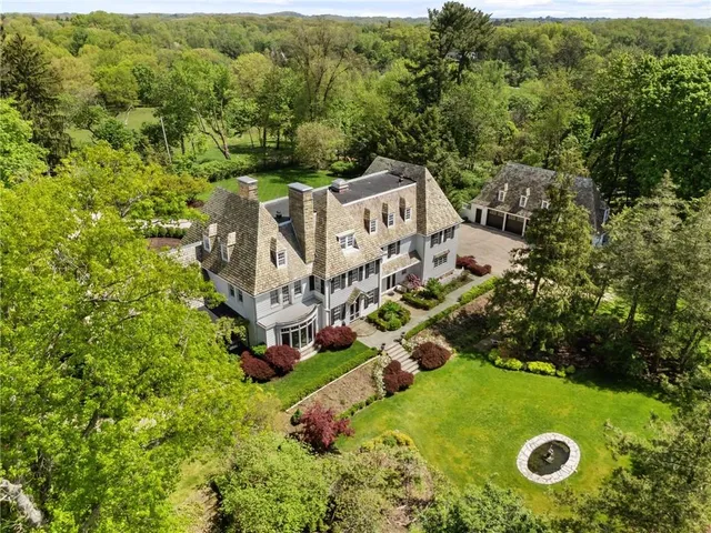 an aerial view of a house with yard swimming pool and outdoor seating