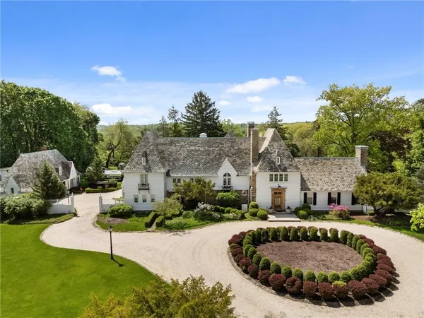 a view of a white house with a swimming pool and a yard