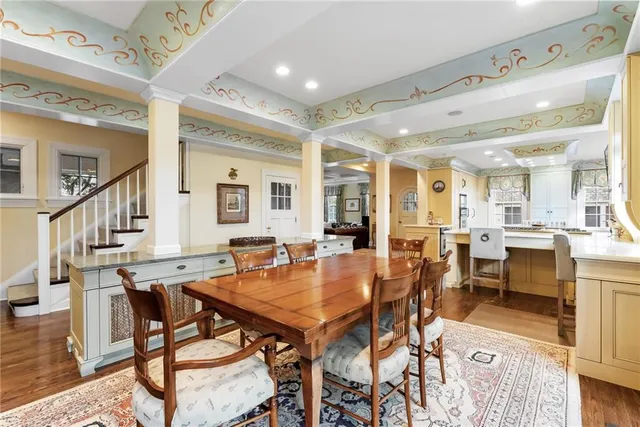 a kitchen with stainless steel appliances a stove a sink dishwasher and a refrigerator with wooden floor