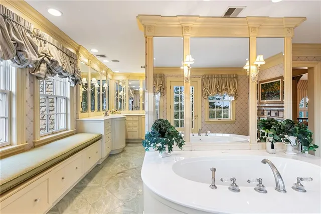 a view of a hallway with cabinet and chandelier