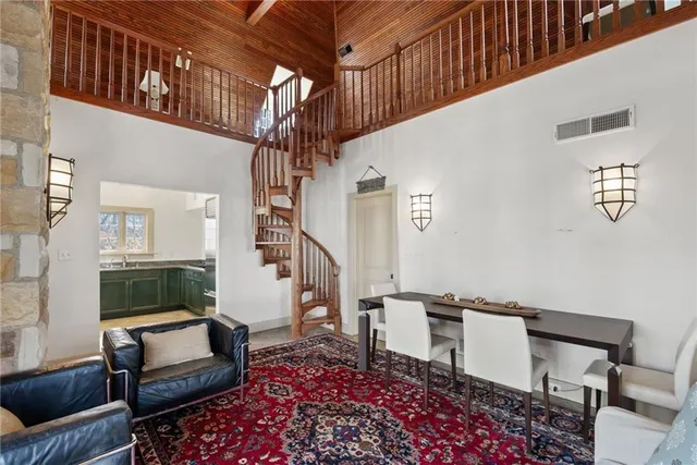a living room with furniture a rug and a flat screen tv
