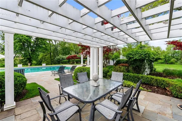 a view of a patio with a table chairs and a backyard