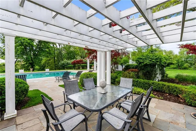 a view of a patio with a table chairs and a backyard