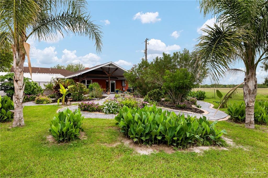 22172 North Olmito Road Rio Hondo, TX 78583 - Photo 30 of 33 a front view of a house with garden