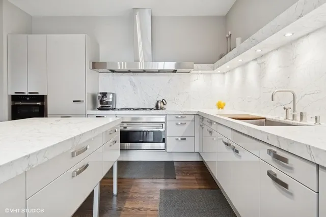 a kitchen with stainless steel appliances a sink stove and cabinets
