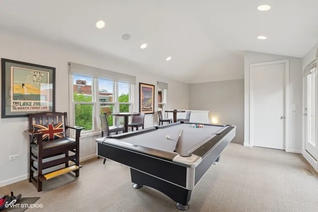 a room with pool table and a large window