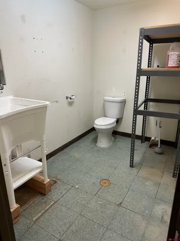 a white toilet sitting next to a bathroom sink