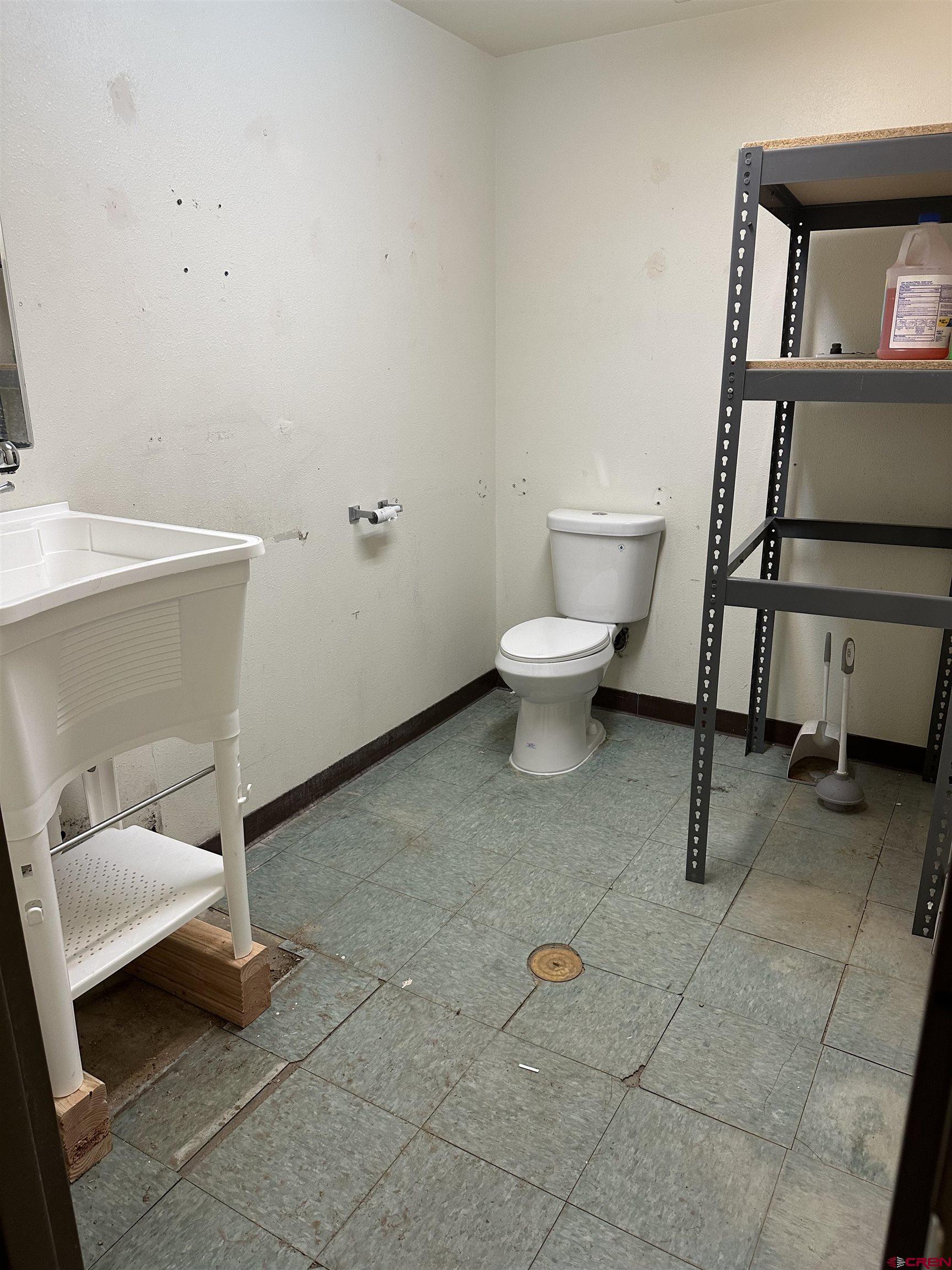 29420 East E Highway, Unit B Durango, CO 81303 - Photo 13 of 15 a white toilet sitting next to a bathroom sink