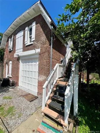 a front view of a house with stairs