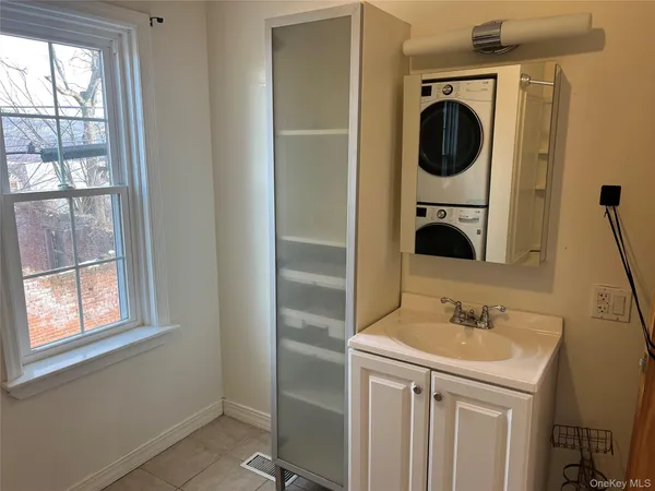 a bathroom with a sink a mirror and window