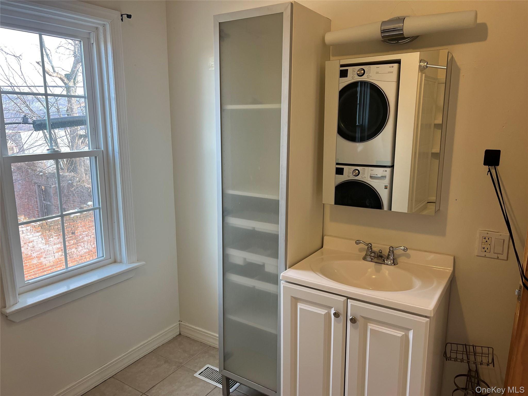 182 Grand Street Newburgh, NY 12550 - Photo 11 of 13 a bathroom with a sink a mirror and window