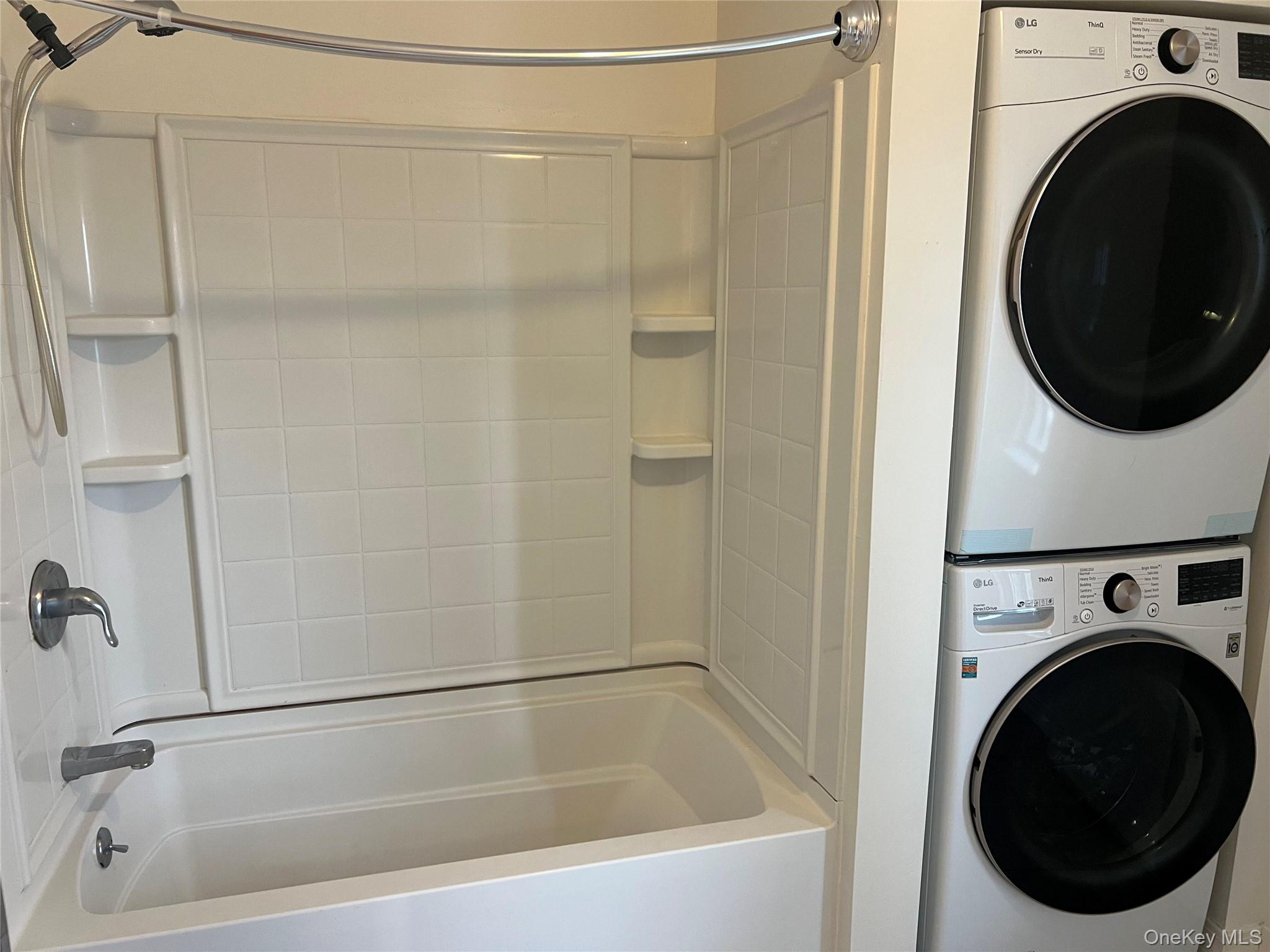182 Grand Street Newburgh, NY 12550 - Photo 12 of 13 a bathroom with a bathtub and a washer dryer