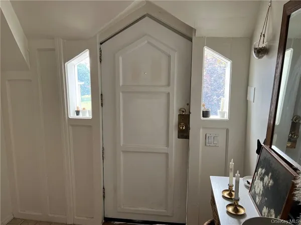 a view of a bathroom with mirror and window
