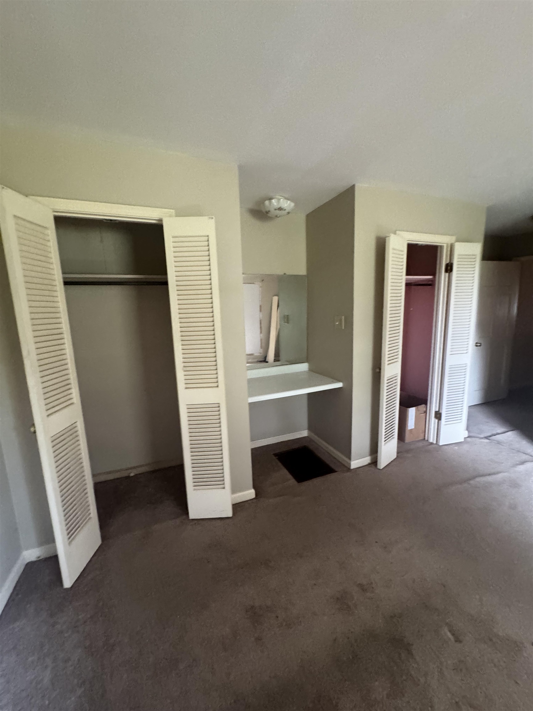 106 Cole Road Drummonds, TN 38023 - Photo 13 of 21 Room featuring two louvered bifold door closets and a built-in vanity with a mirror