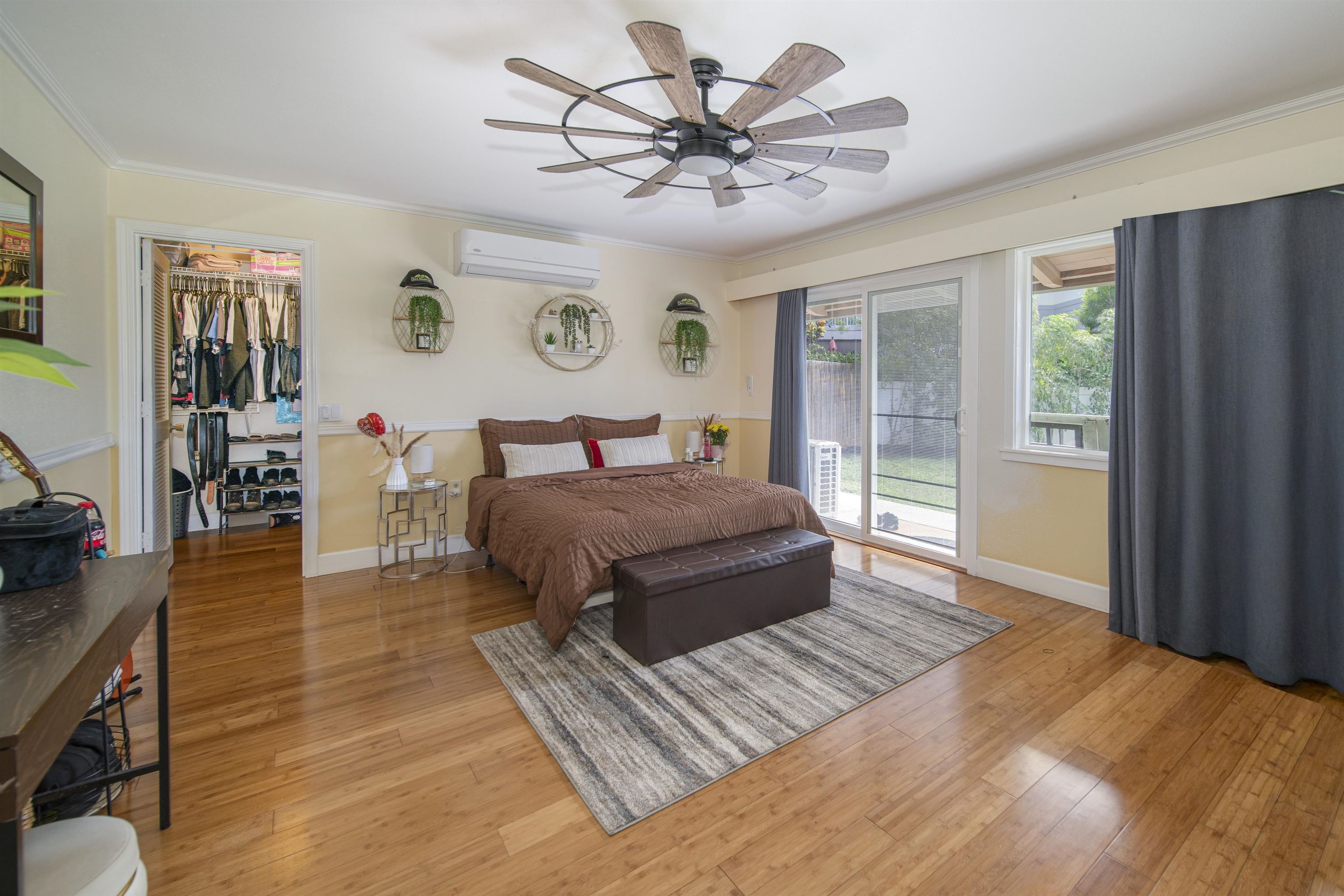 4996 Lower Honoapiilani Road Lahaina, HI 96761 - Photo 17 of 37 a bedroom with a large bed and a chandelier