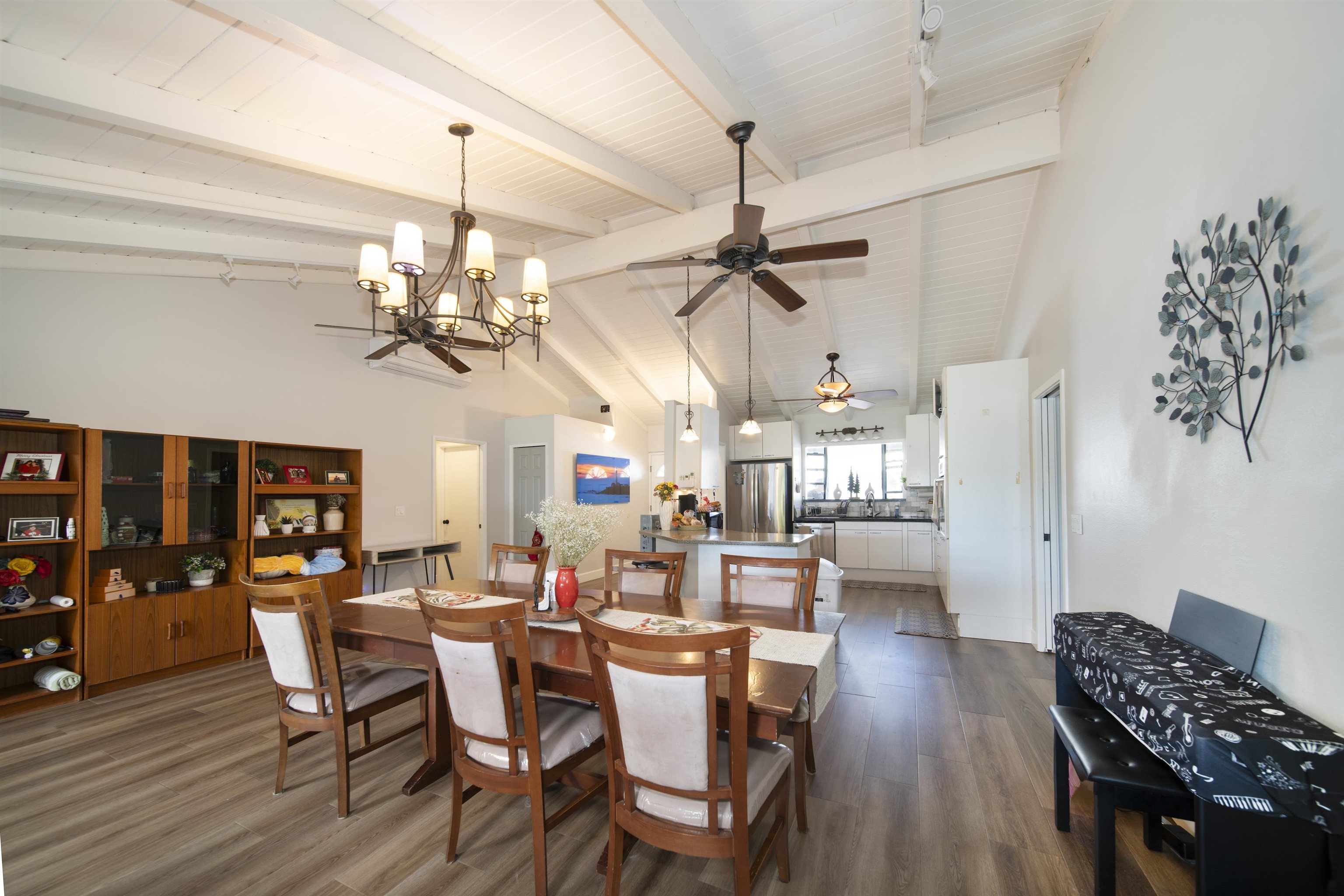 4996 Lower Honoapiilani Road Lahaina, HI 96761 - Photo 2 of 37 a view of a dining room and livingroom with furniture wooden floor a chandelier