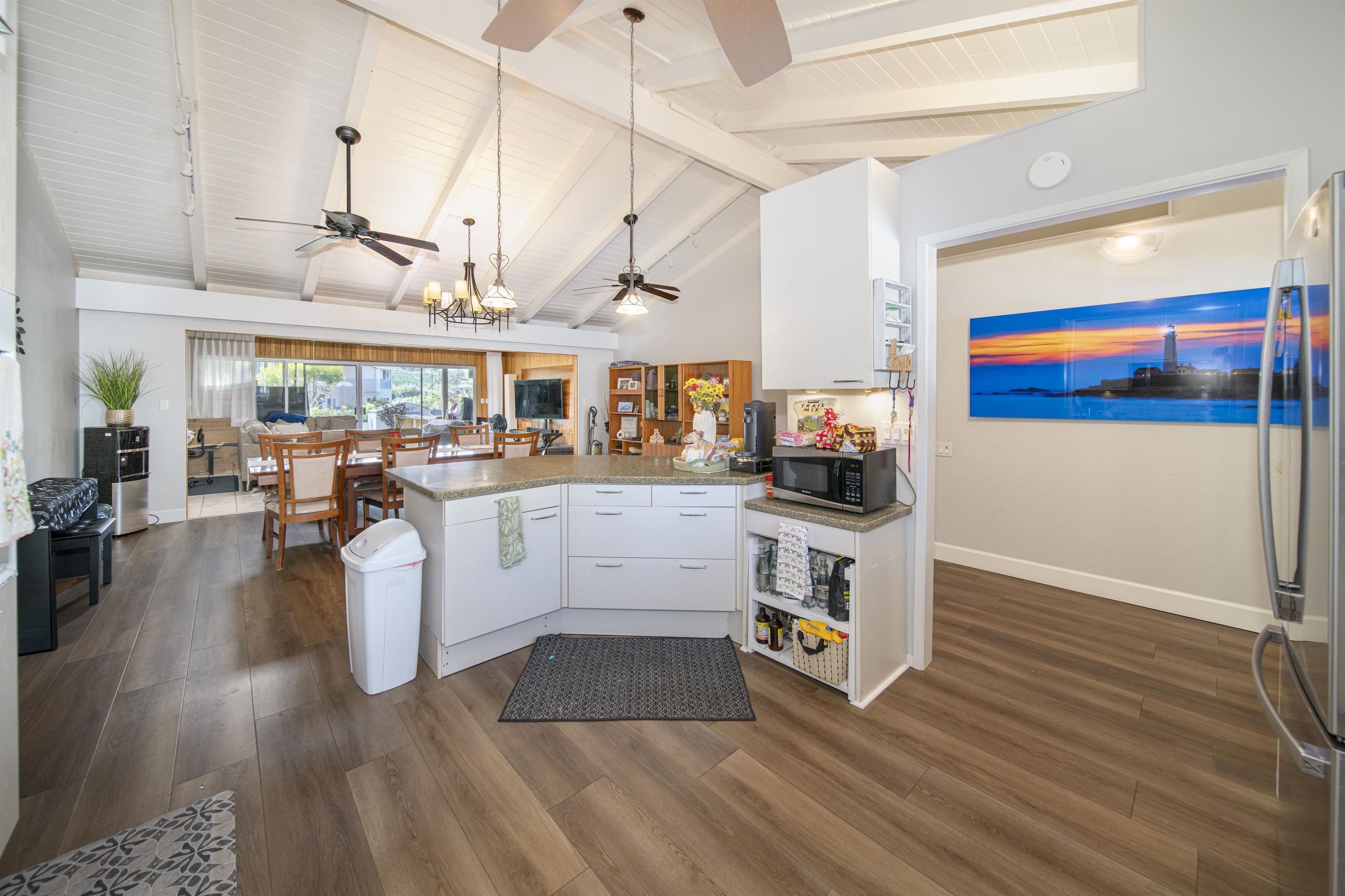 4996 Lower Honoapiilani Road Lahaina, HI 96761 - Photo 25 of 37 a kitchen with stainless steel appliances granite countertop a stove and wooden floor