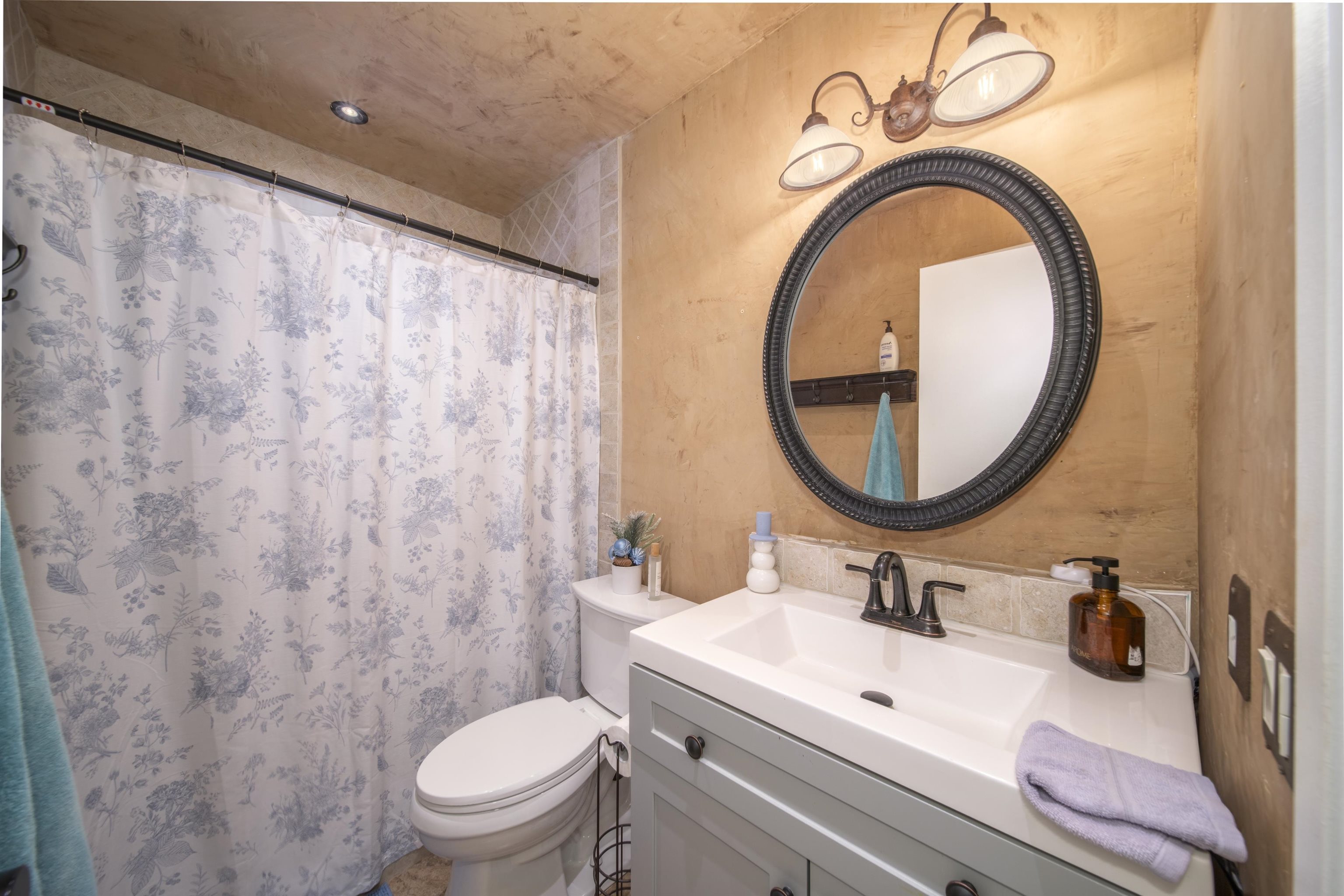 4996 Lower Honoapiilani Road Lahaina, HI 96761 - Photo 32 of 37 a bathroom with a sink a toilet and a mirror