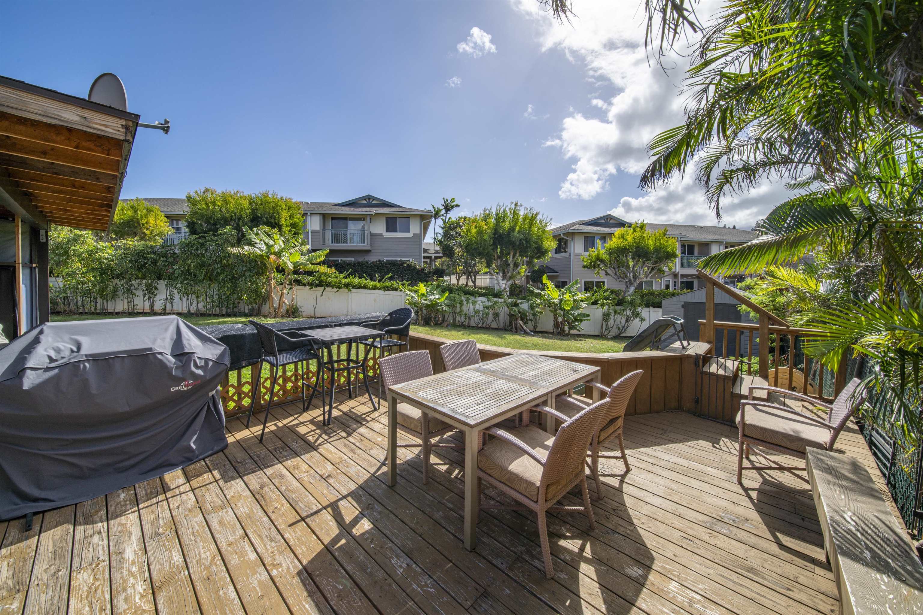 4996 Lower Honoapiilani Road Lahaina, HI 96761 - Photo 8 of 37 a view of a patio with table and chairs and potted plants with wooden floor and fence