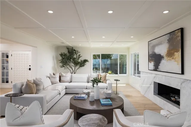 a living room with furniture a fireplace and a large window