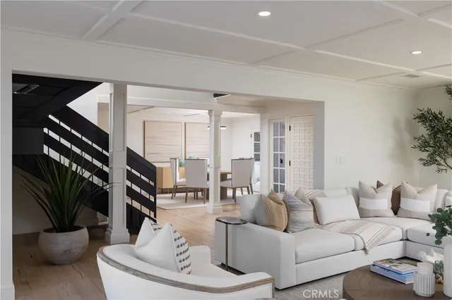 a living room with furniture and a potted plant