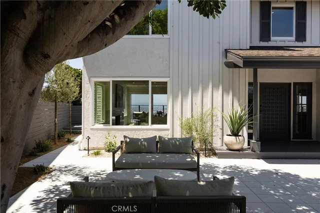 a building outdoor space with patio furniture and potted plants