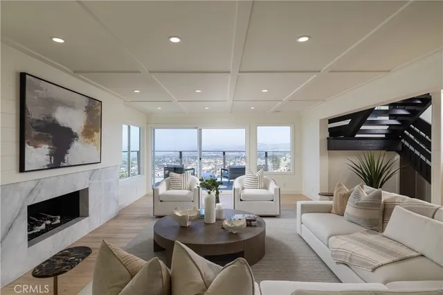 a living room with furniture a fireplace and a flat screen tv