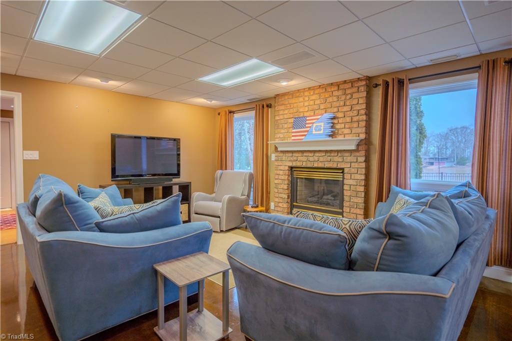 1835 Waterford Pointe Road Lexington, NC 27292 - Photo 20 of 26 Lower level den /recreation room with fireplace/gas logs and great view of lake.