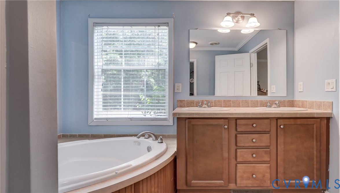 8025 Colemans Lake Road Church Road, VA 23850 - Photo 14 of 21 a bathroom with a tub a sink and a window