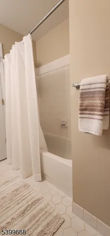 a bathroom with a bathtub and shower
