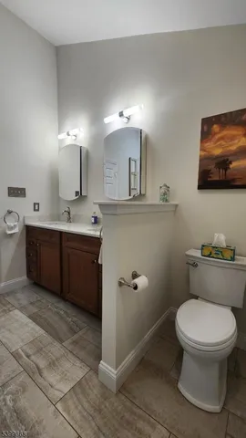 a bathroom with a toilet a sink and mirror