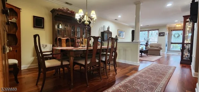 a view of a dining room with furniture and wooden floor