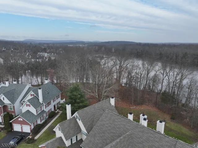 an aerial view of a house with a yard and lake view