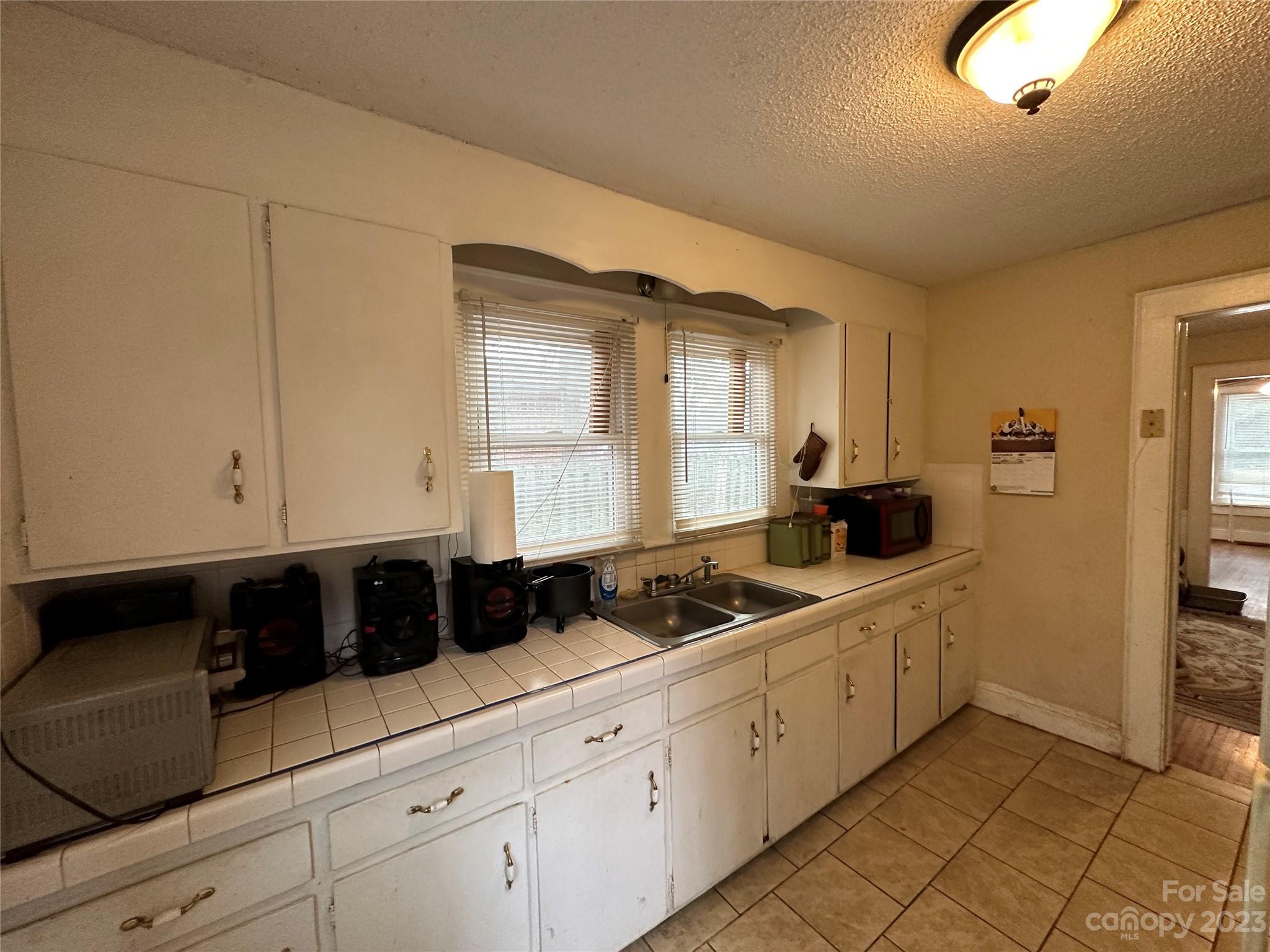 1403 Ln Street Kannapolis, NC 28083 - Photo 14 of 20 a kitchen with stainless steel appliances granite countertop white cabinets and window