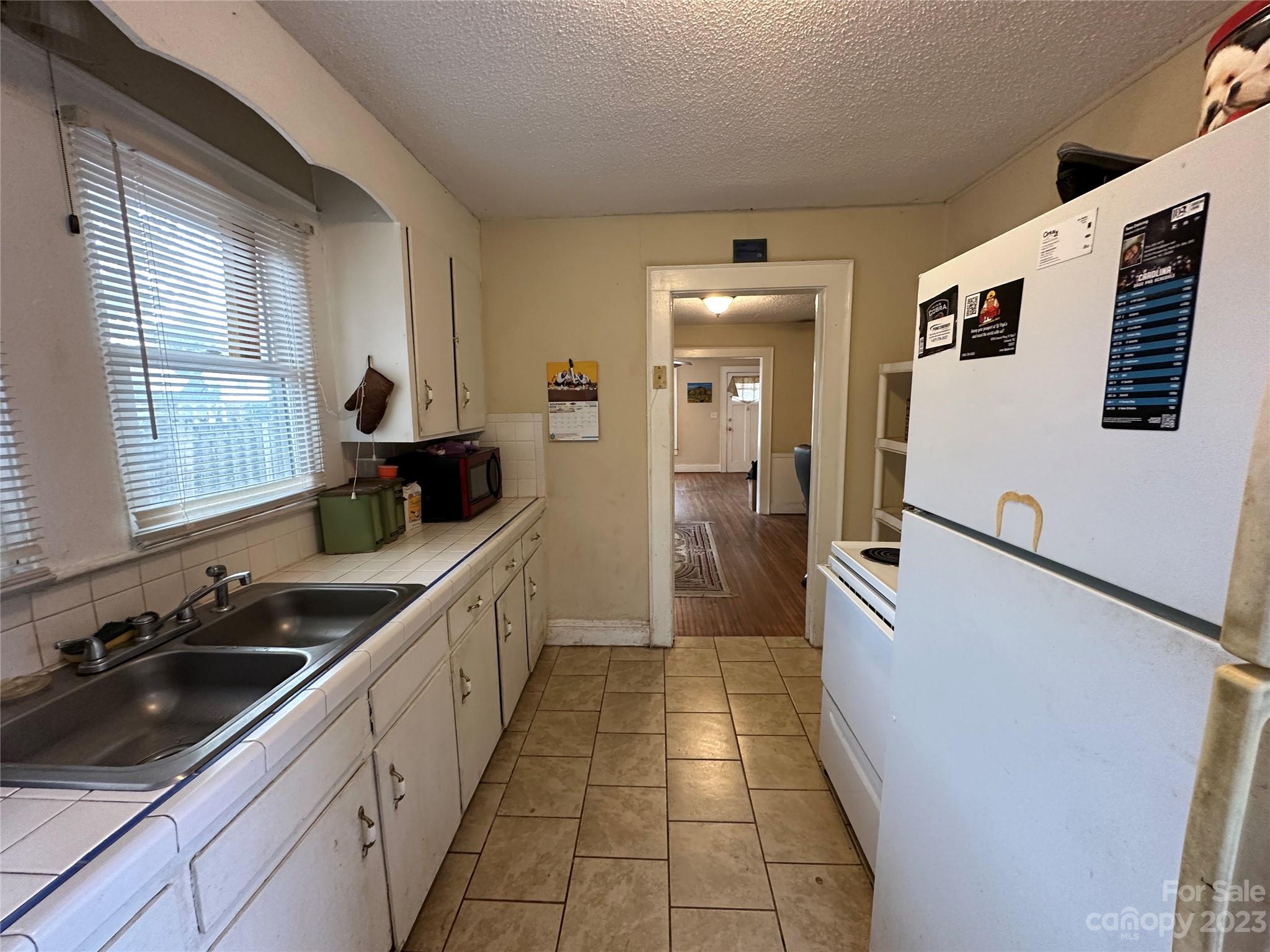 1403 Ln Street Kannapolis, NC 28083 - Photo 15 of 20 a kitchen with stainless steel appliances granite countertop a sink stove and refrigerator
