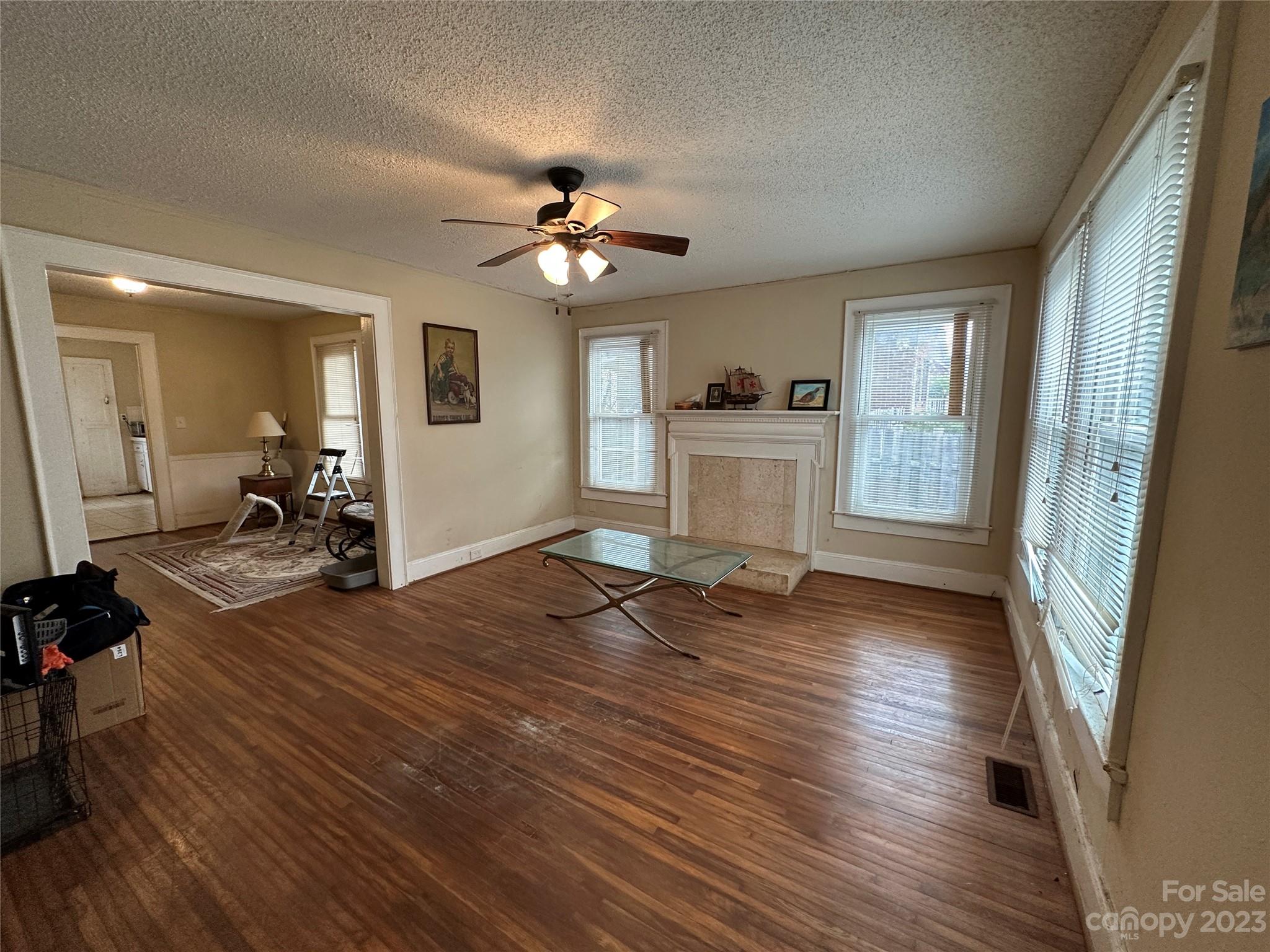 1403 Ln Street Kannapolis, NC 28083 - Photo 8 of 20 a view of a livingroom with hardwood floor and a ceiling fan
