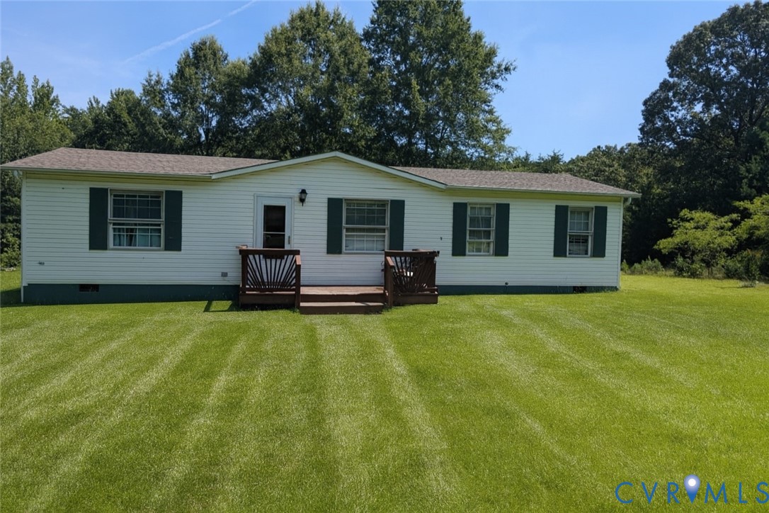 Back of house featuring a deck, crawl space, and a