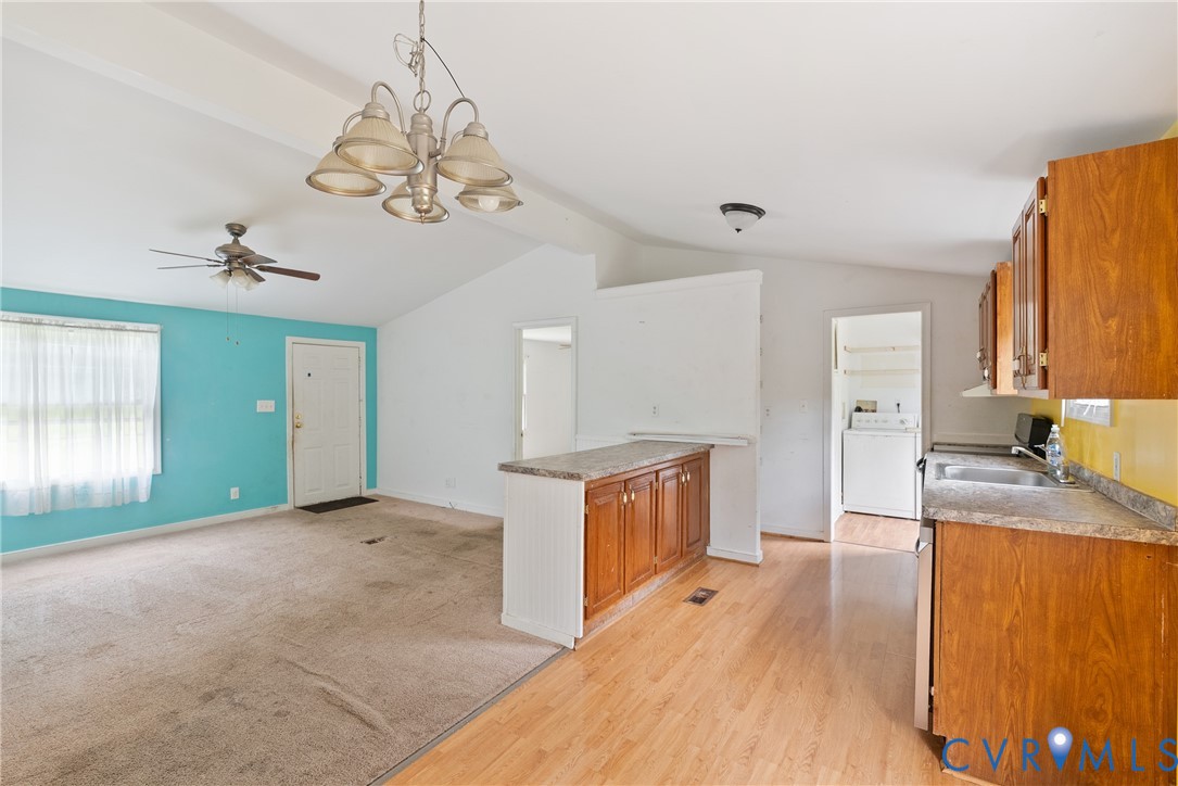 20786 Beaver Dam Road Beaverdam, VA 23015 - Photo 17 of 23 Kitchen with brown cabinets, a chandelier, light w