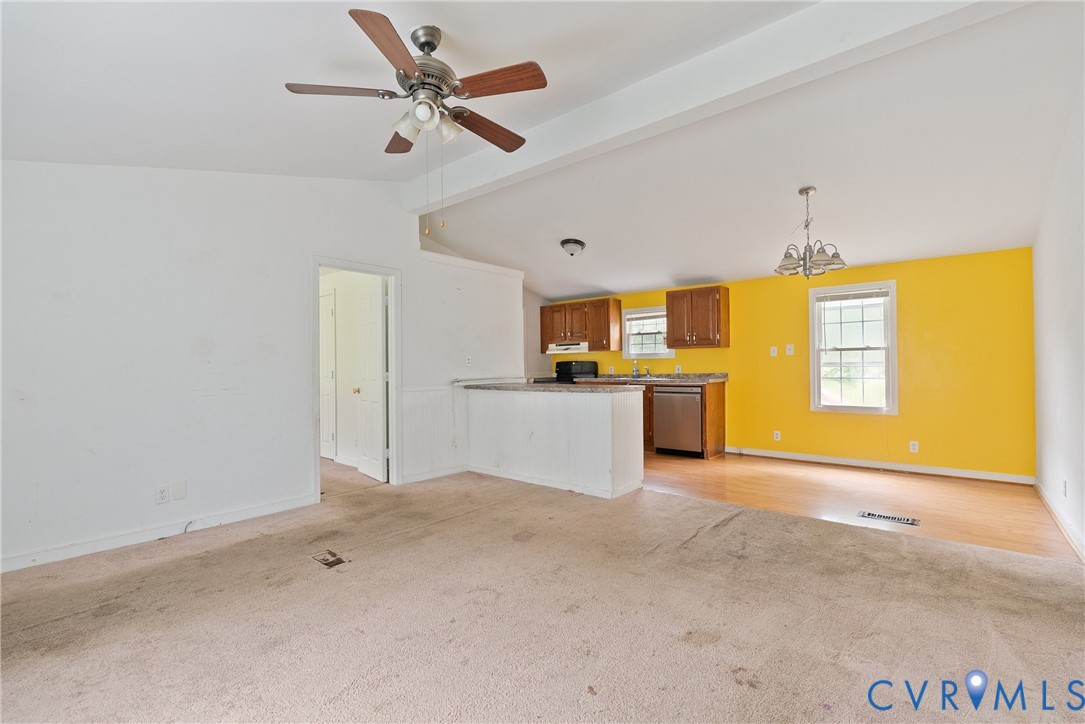 Unfurnished living room with light carpet, a chand