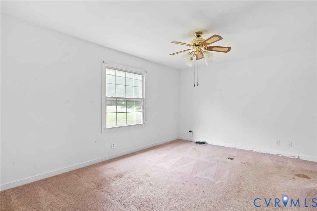 Carpeted empty room featuring baseboards and ceili