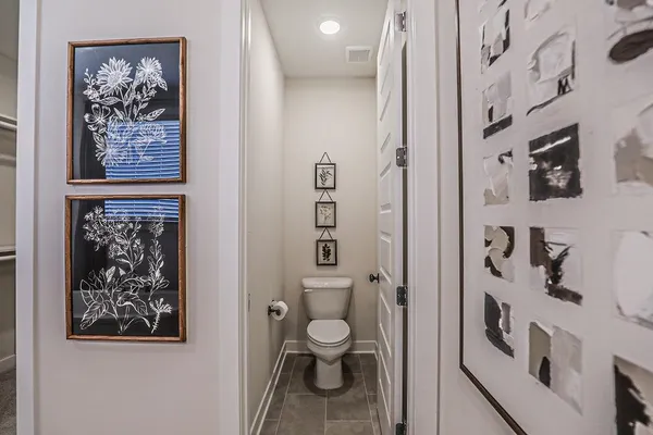 a bathroom with a granite countertop toilet a sink and a mirror