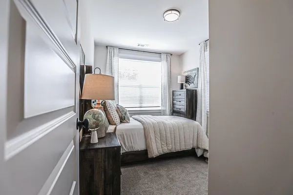 a bedroom with bed and wooden floor