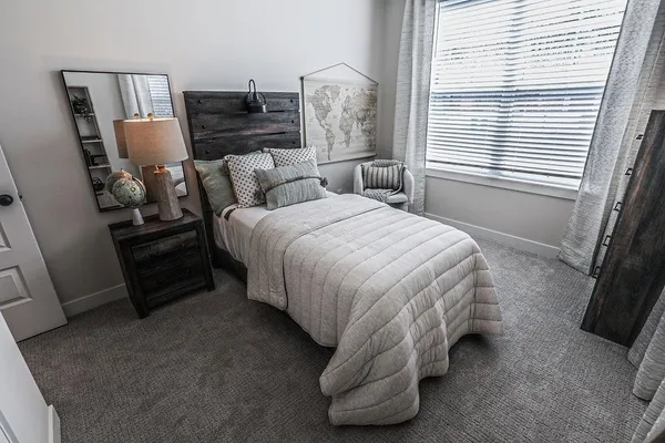 a bedroom with a bed and a television
