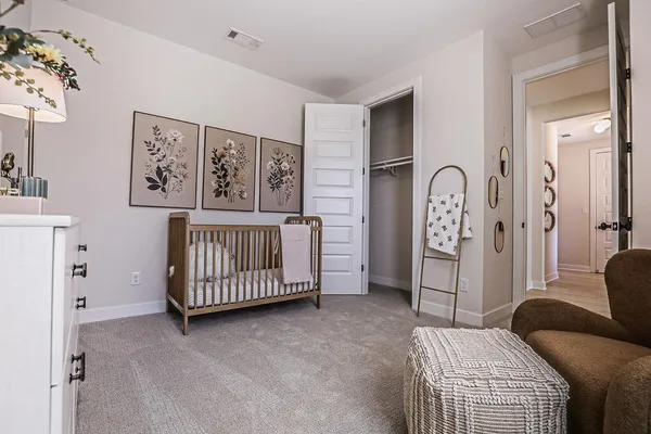a bedroom with furniture and baby crib