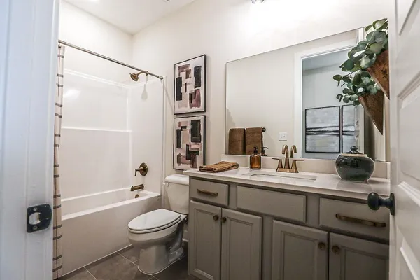 a bathroom with a sink toilet tub and shower