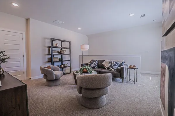a living room with furniture and a potted plant