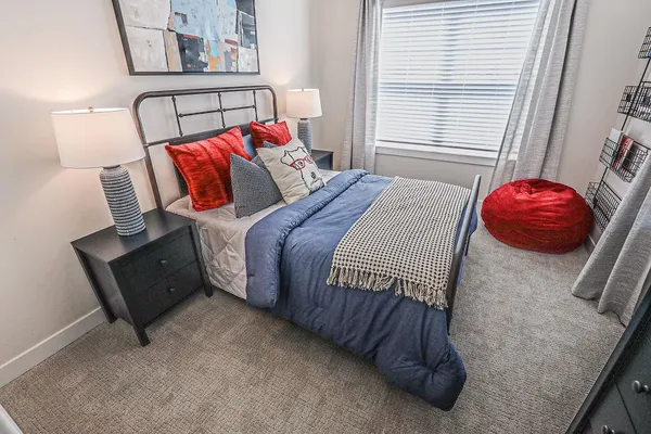 a bedroom with a bed and window