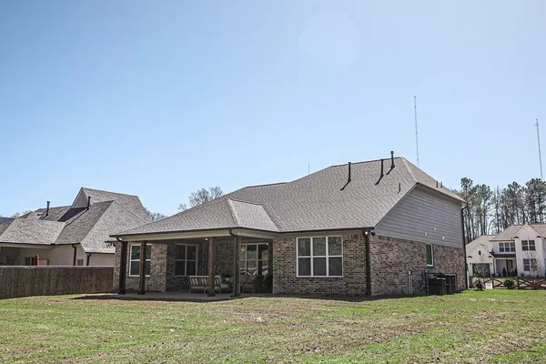 a front view of a house with a garden