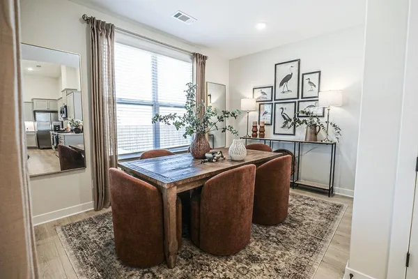 a dining room with table and chairs
