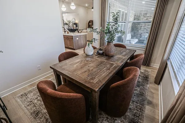 a dining room with furniture and window